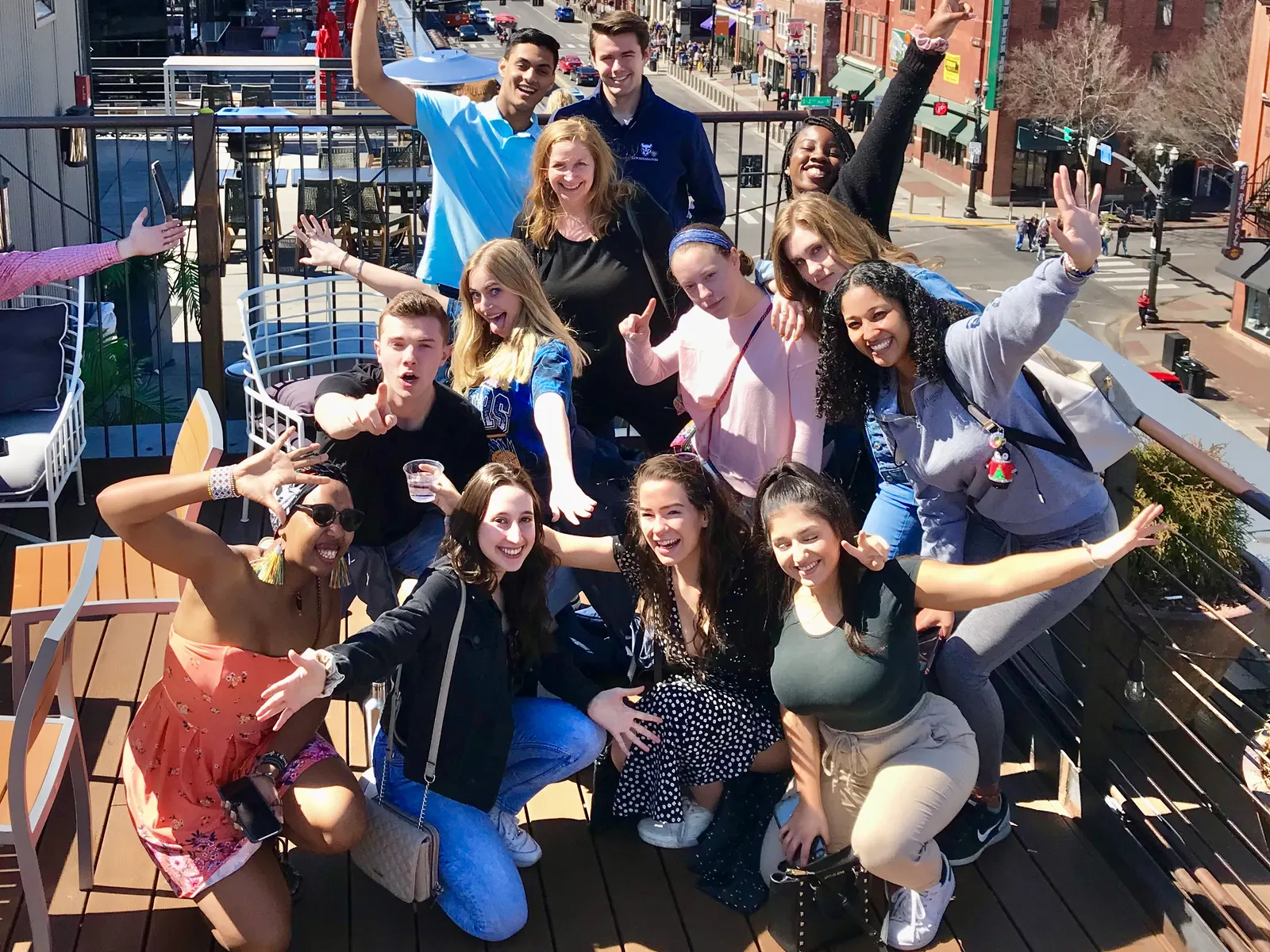 Group of friends celebrating on a rooftop over Broadway in Nashville