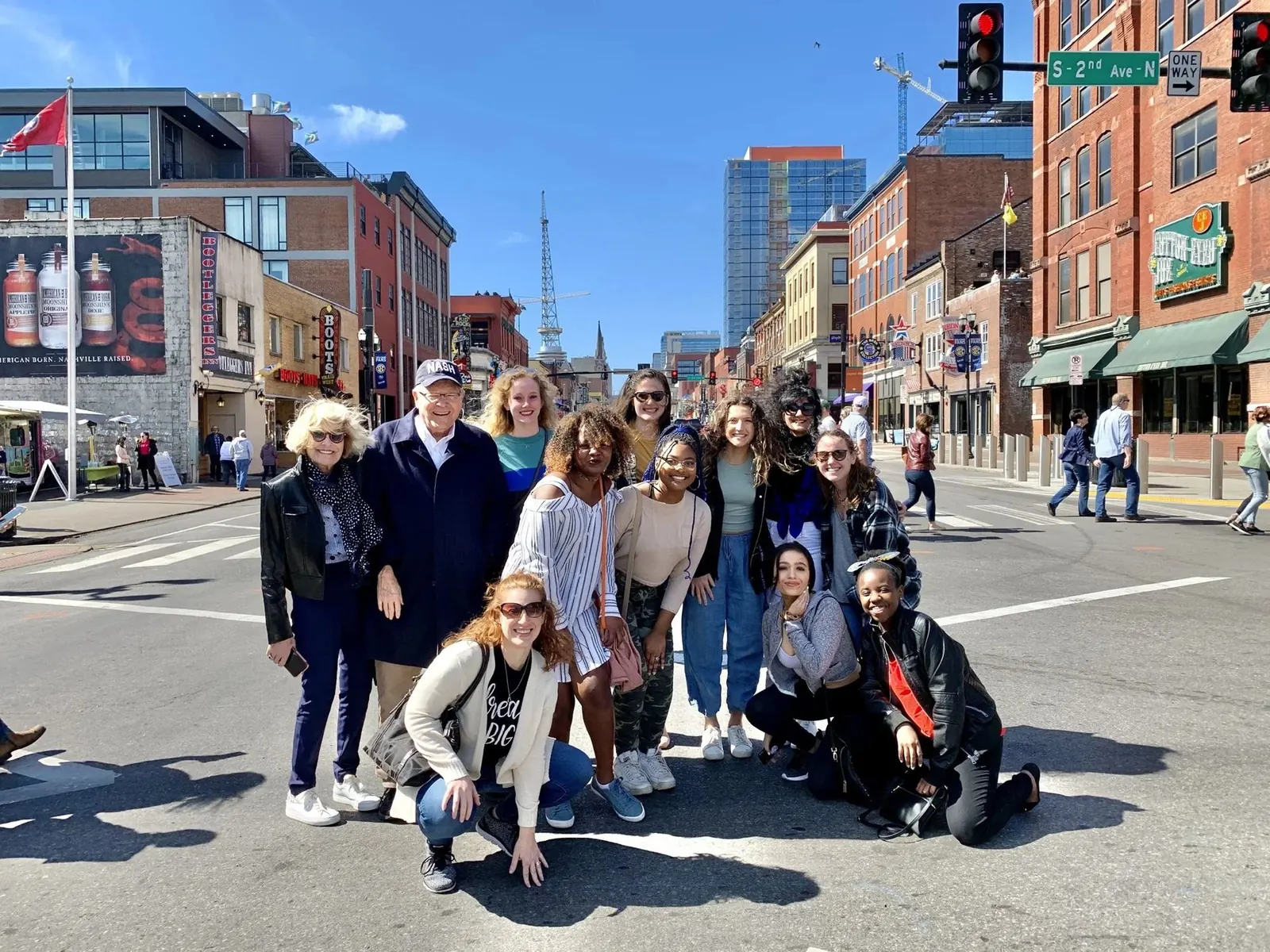 A food tour group with the downtown Nashville skyline behind them
